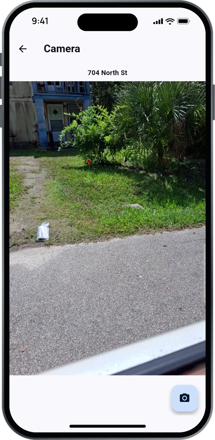 CarrierTrack camera screen at 704 North St showing a bagged newspaper on the driveway.